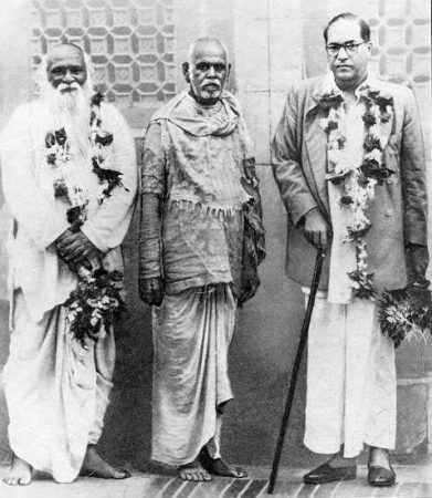Black and white photograph of Bhaurao Patil, Sant Gadge Baba in patched clothes, and Dr B. R. Ambedkar, all wearing garlands.